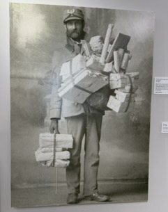 Early mail carrier loaded with packages