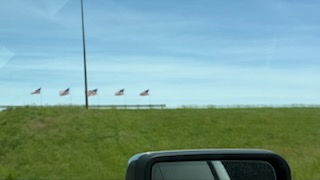 American flags lining the highway embankment