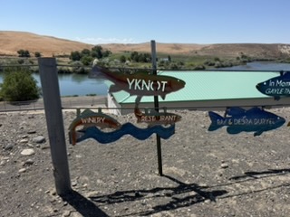 Named metal fish on a fence near Glenns Ferry